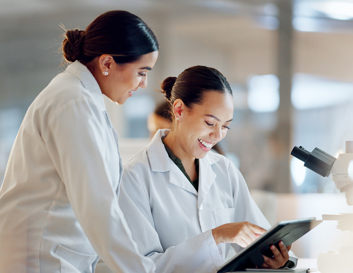 Researchers collaborating in a lab to accelerate treatment development through global partnerships