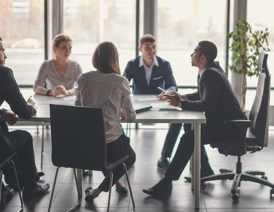 Business leaders in discussion, reflecting JCR’s focus on ethical and transparent governance