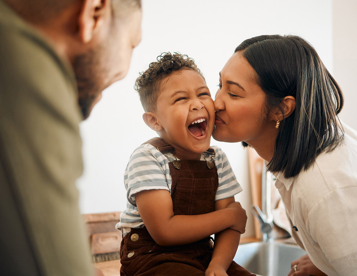 A joyful moment between parents and child, reflecting equitable access to rare disease treatment